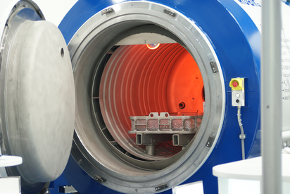Gas nitriding system RUBIG with open chamber – glowing interior and workpiece holder for heat treatment